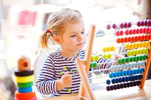 A child playing with toys at nursery
