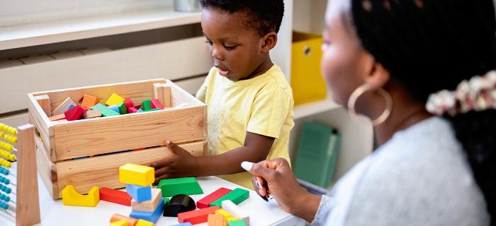 A child at preschool playing with building blocks