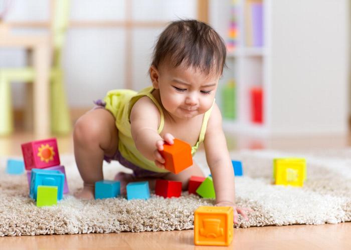 Baby playing with building blocks