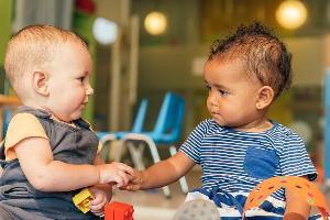 Two babies playing at nursery